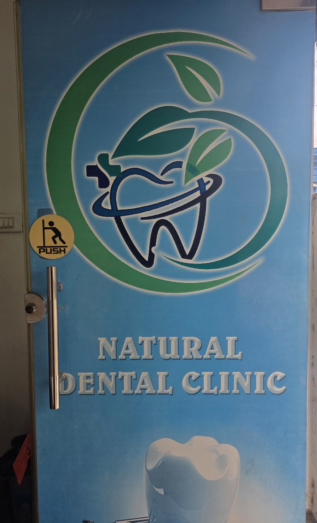 Branded entrance door at Natural Dental Clinic