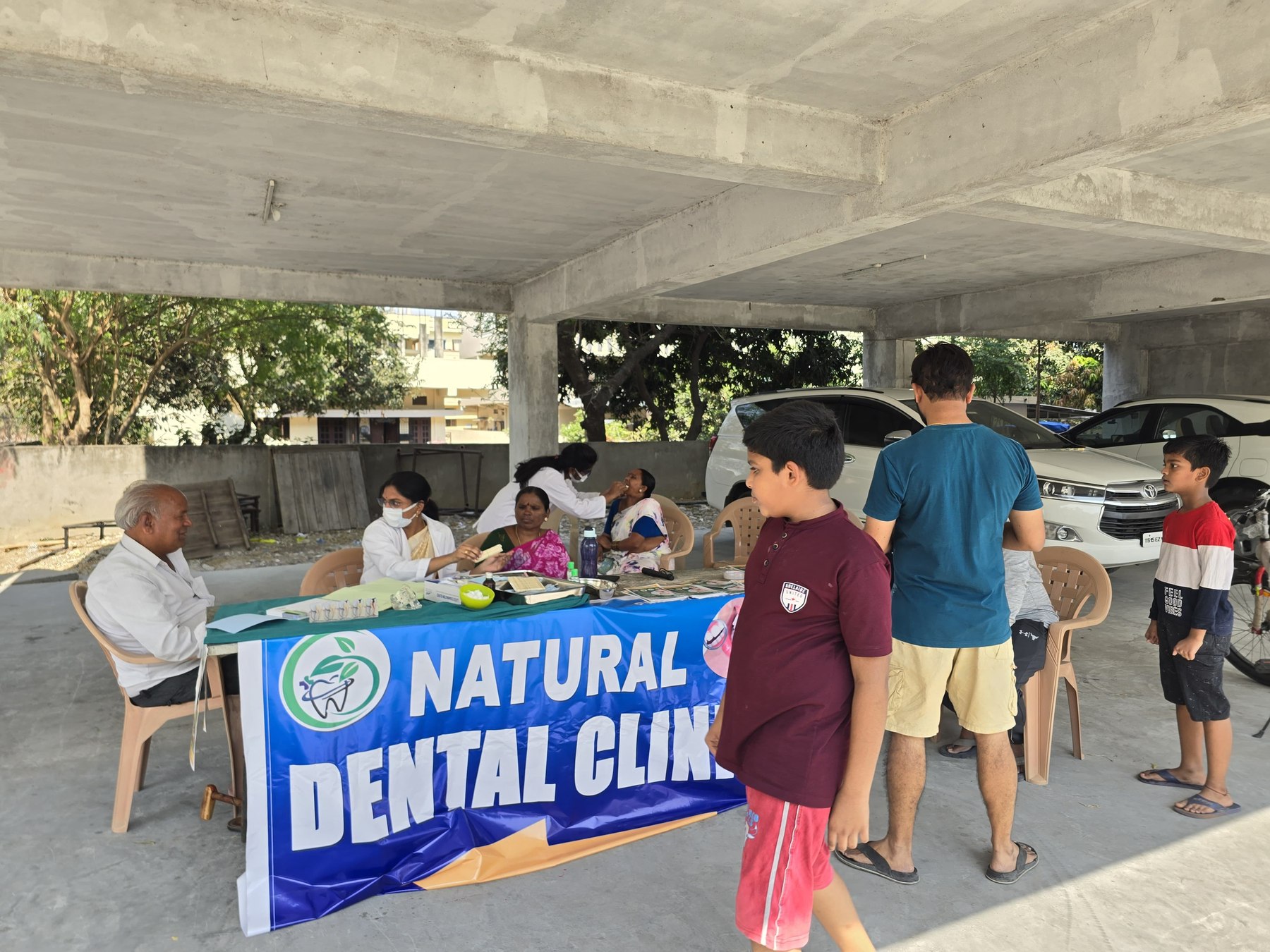 Natural Dental Clinic team providing check-ups at a community dental camp